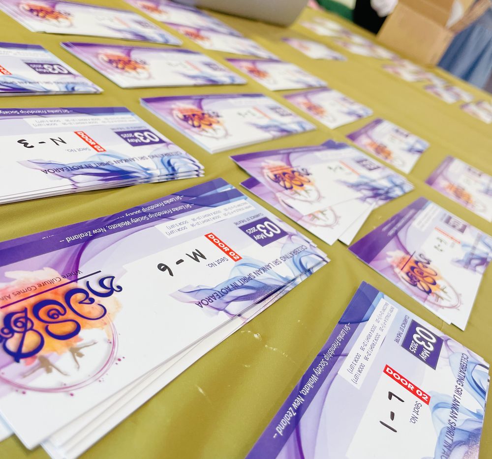 Printed Nawamini tickets laid out on a table with handwritten seat numbers